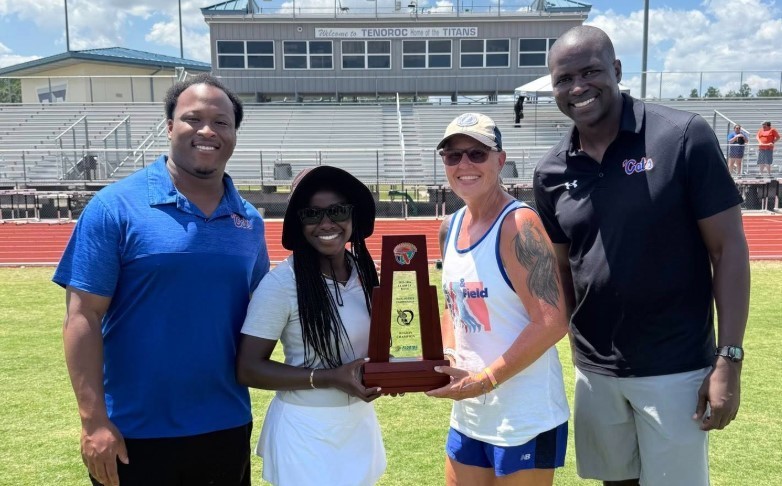 HHS Track and Field team members with a trophy