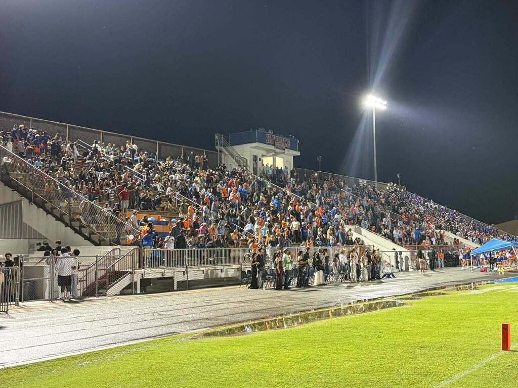 bleachers full of people watching the football game
