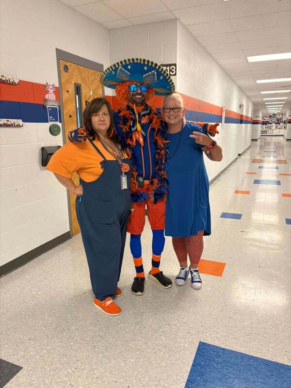 staff dressed for spirit week in orange and blue