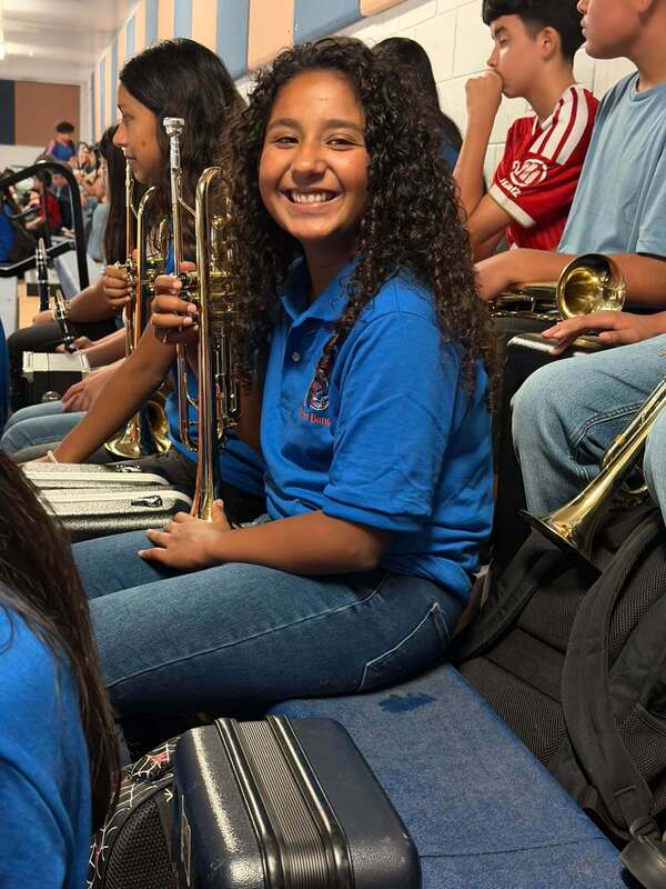 trumpet player waiting for the pep rally to begin