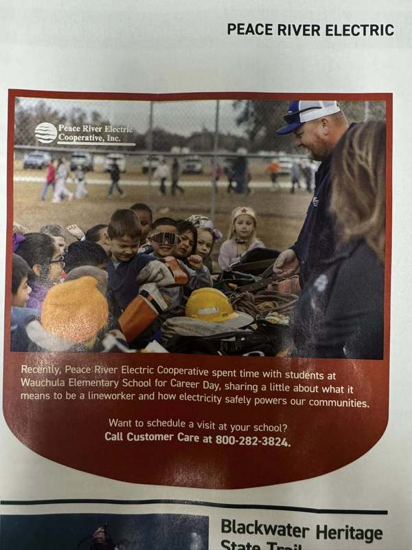 students looking at a table of line worker equipment