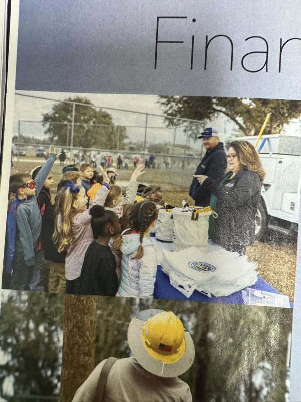 Students with their hands raised to answer a question