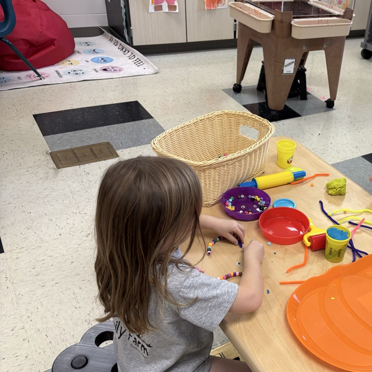 working on fine motor with play-doh and beads