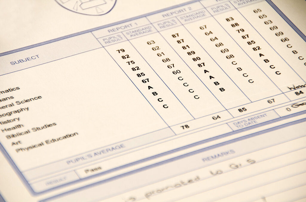 A table of numbers and letters with columns labeled "Subject", "Grades", and "Comments" appears on a white background.