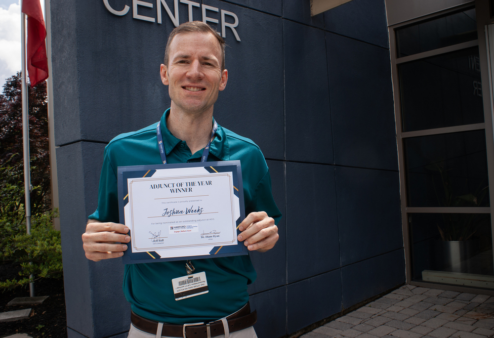 Mr. Joshua Weeks poses with certificate