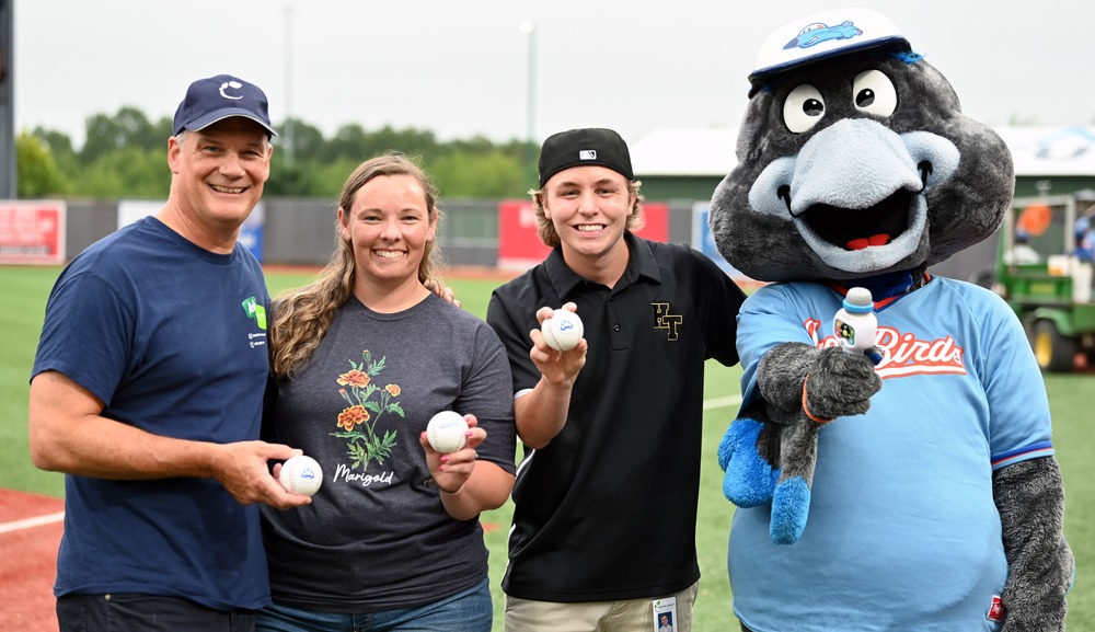 Dr. Bulson, Shelby Hultquist and Trae McVicker pose with Ferrious, the Iron Birds mascot, before first pitch