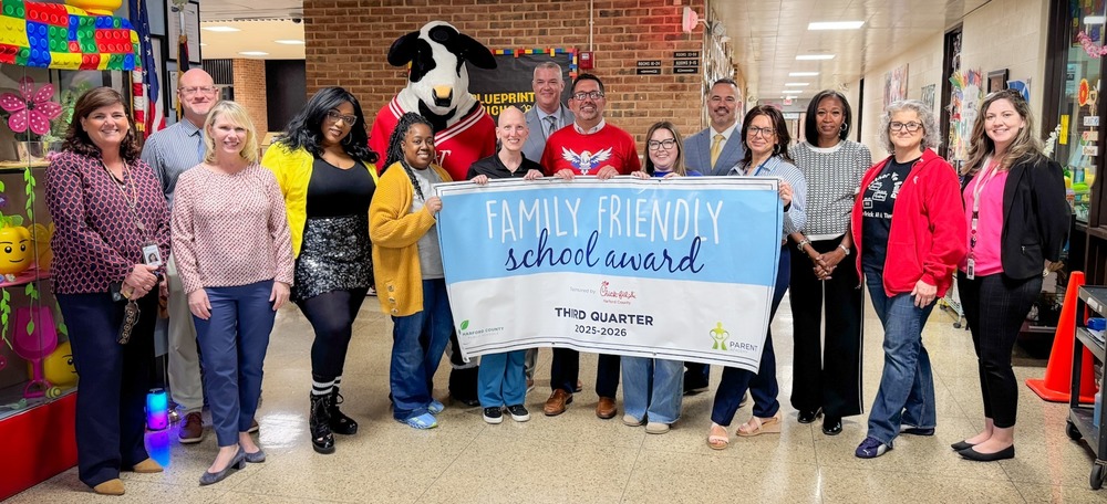 staff at Harford Academy stand with a banner that says "Family Friendly School Award" and "Third Quarter".