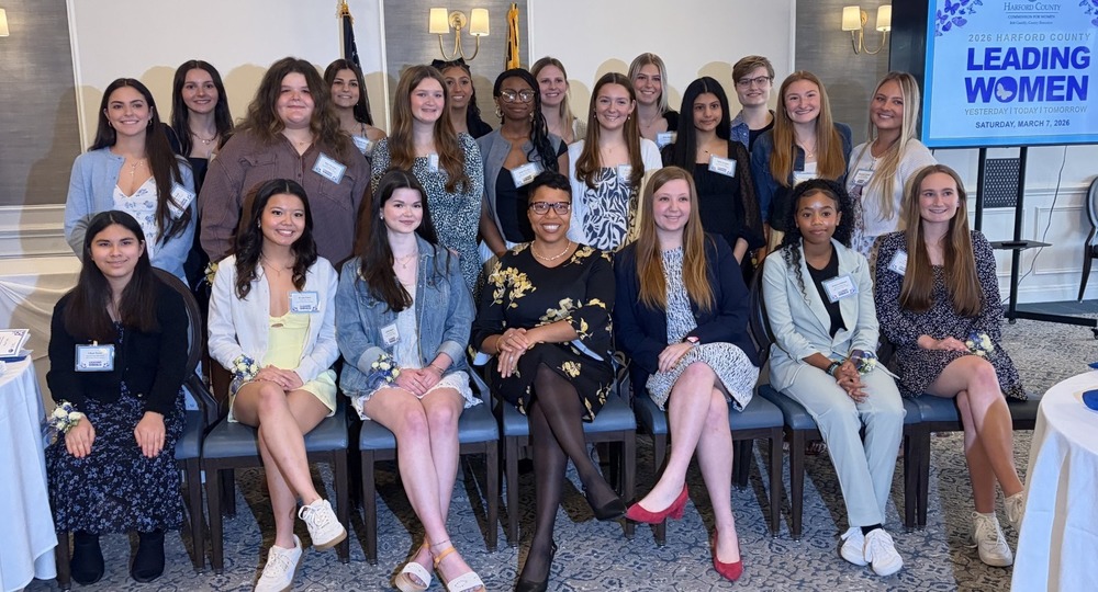 Group of young women seated around Dr. Dyann Mack, Superintedent of Harford County Public Schools
