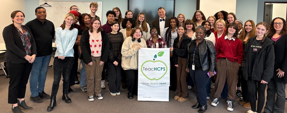 Students stand in a group around Dr. Sean Bulson