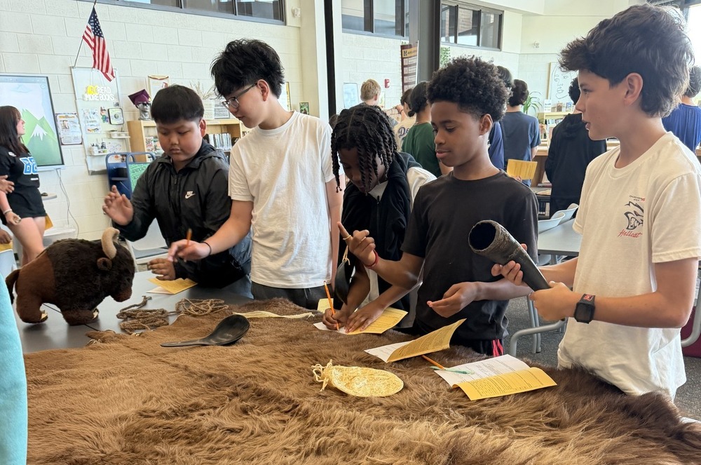 Students around an animal pelt