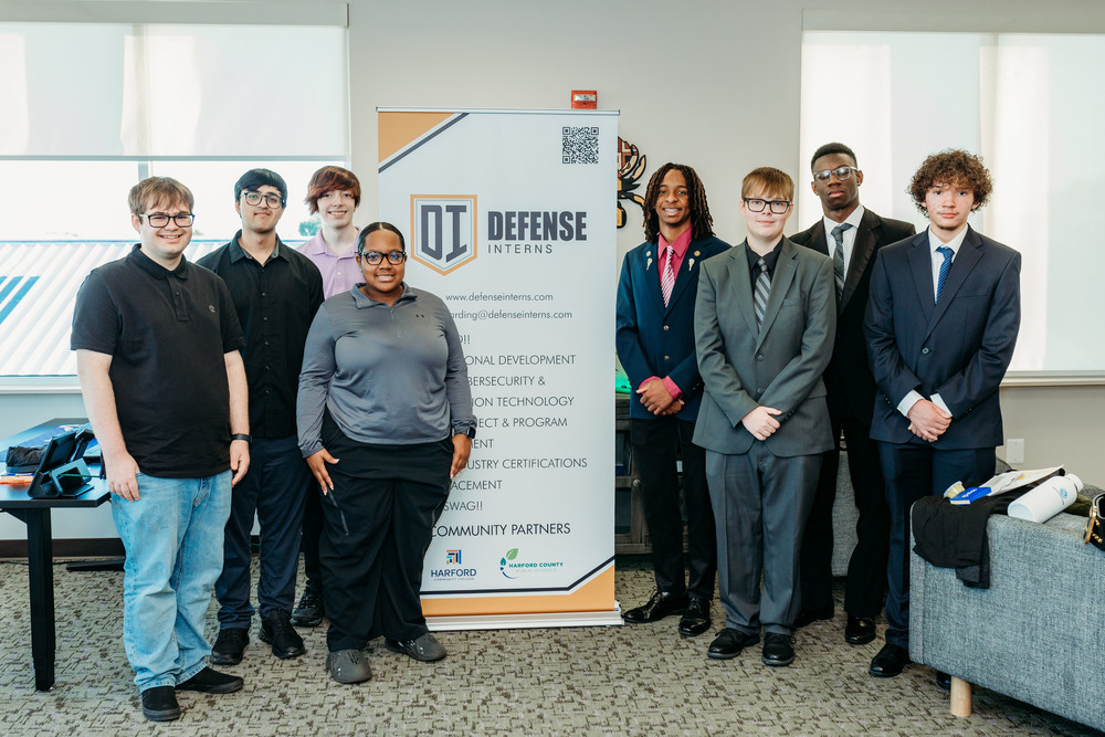 Group of students in front of a banner