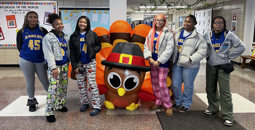 Students pose with a blow up turkey