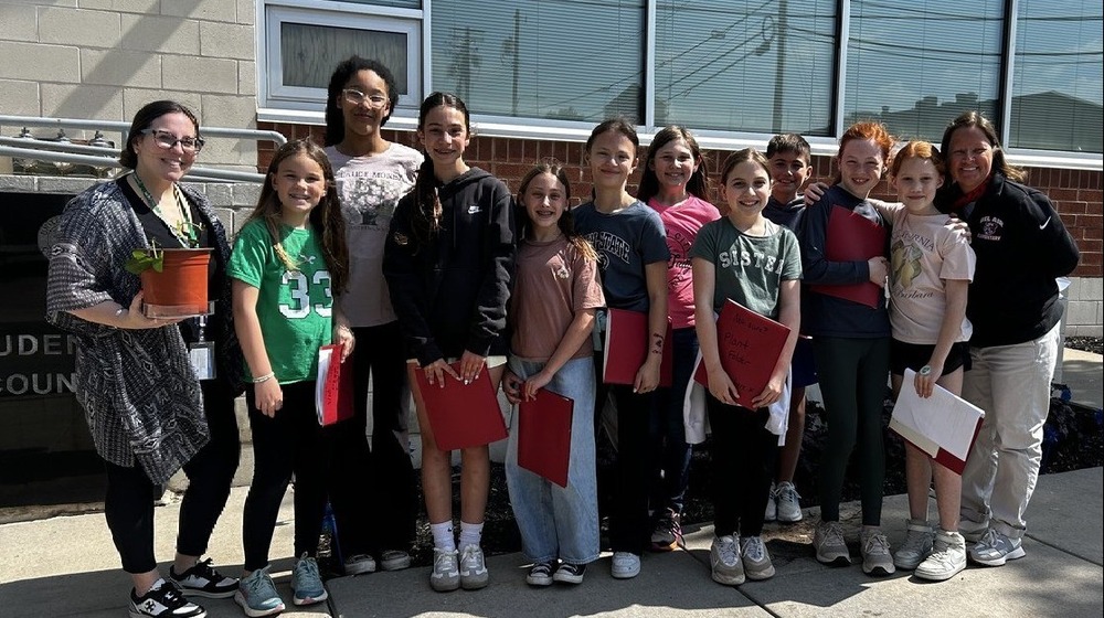 Group of students standing outside in front of a building