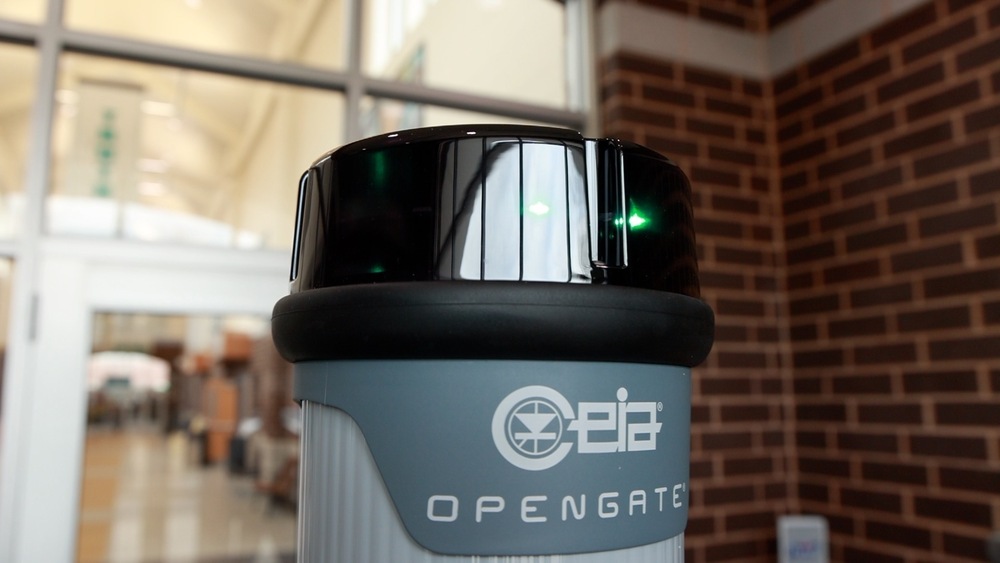Top of Open Gate device seen with green light in front of school doors.