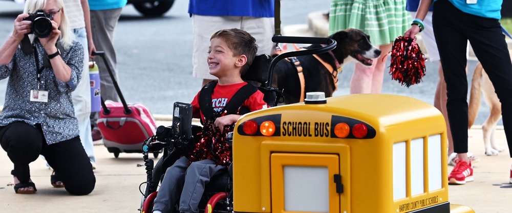 Child in a wheel chair smiles 