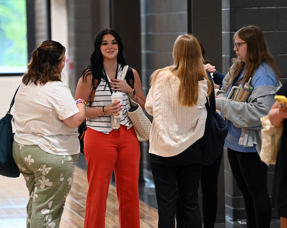 Group of teachers talking in a hallway