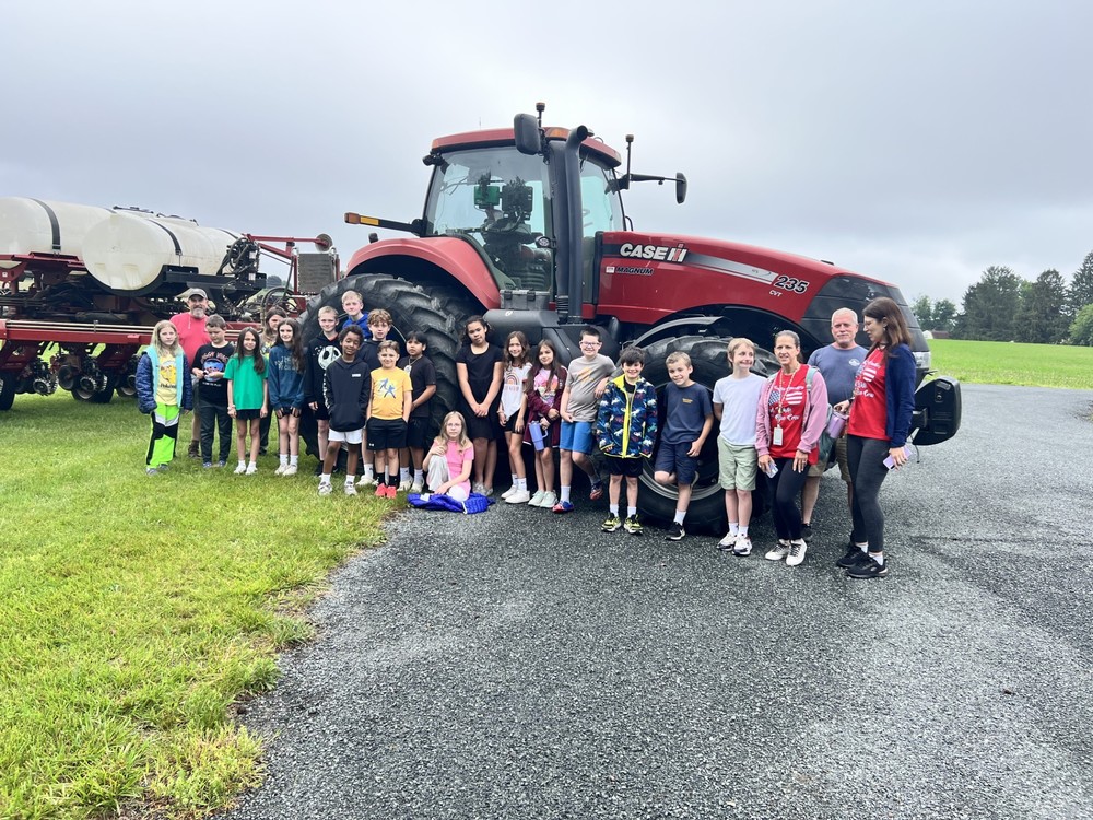 Students in front of a tractor