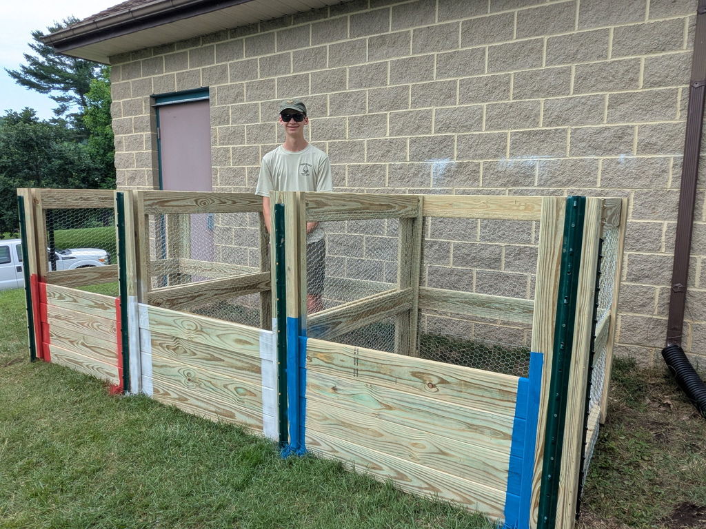 Evan Welch stands near compost bins at Harford Glen