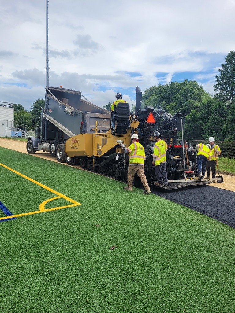 crews laying ashphalt down to replace an old track