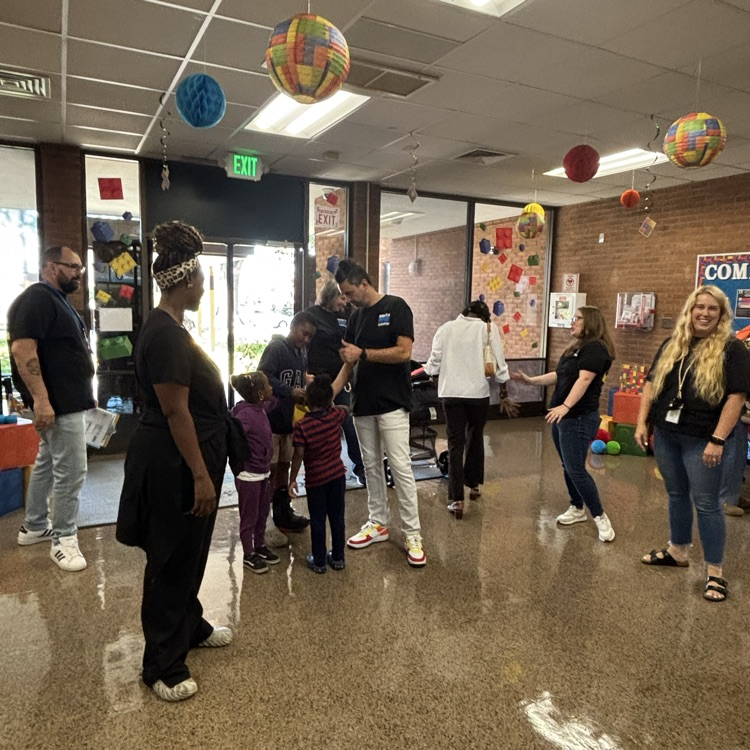 Staff greeting students at the entrance