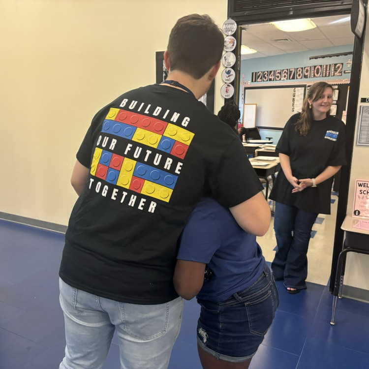 teacher hugging a student