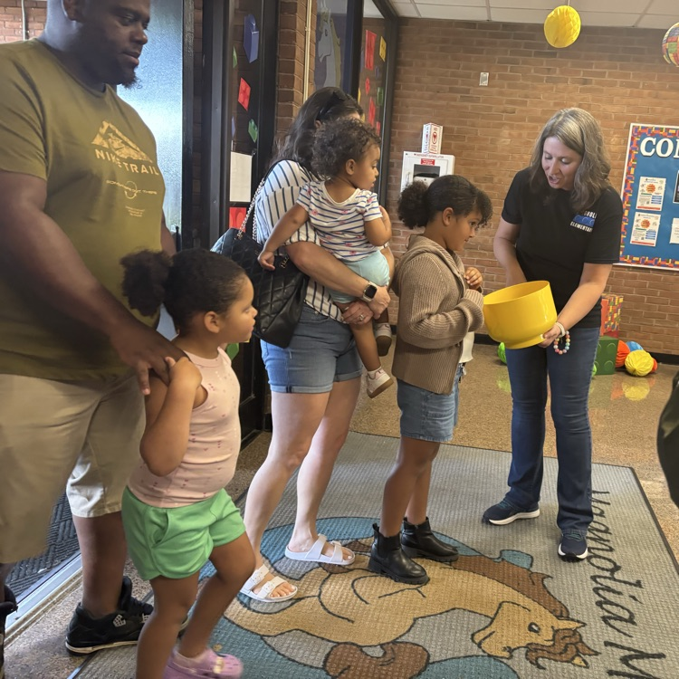 Mrs. Brown greeting families at the door