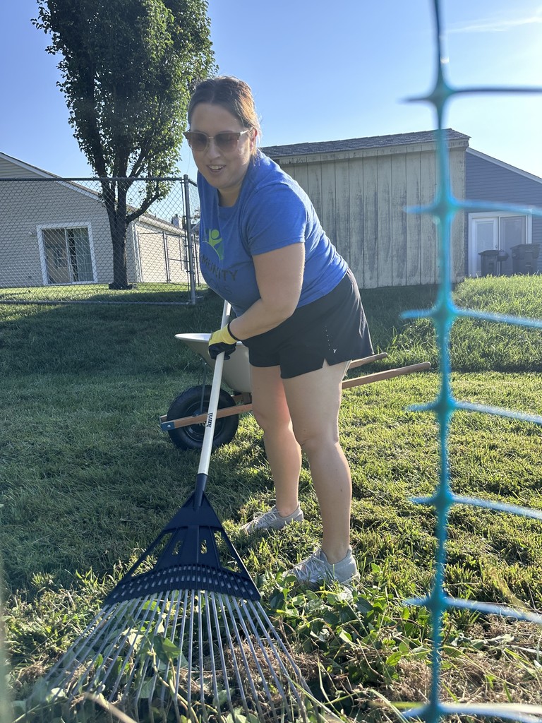 A woman raking a garden.