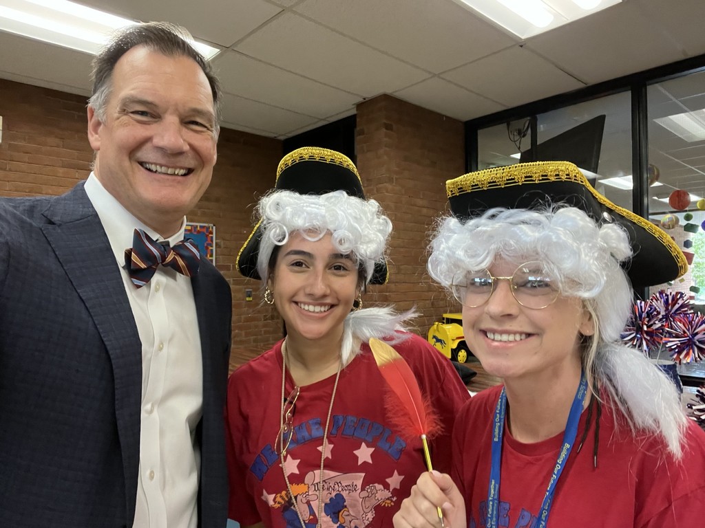 Dr. Bulson posing with two staff members dressed like founding fathers