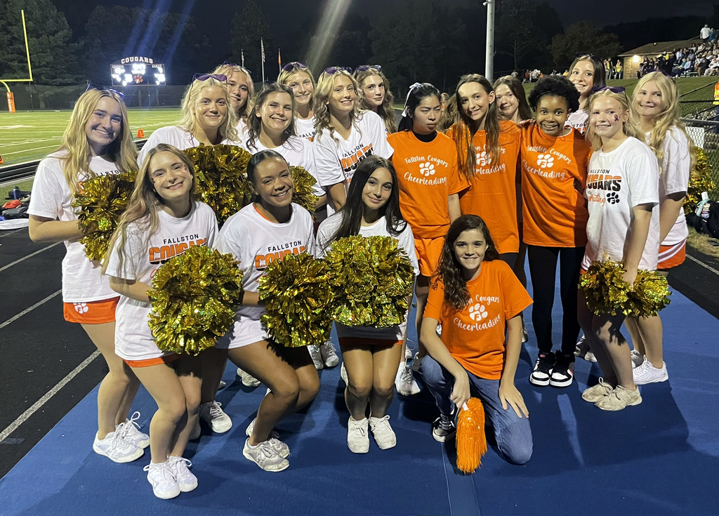 High school cheerleaders on the sidelines of a football game