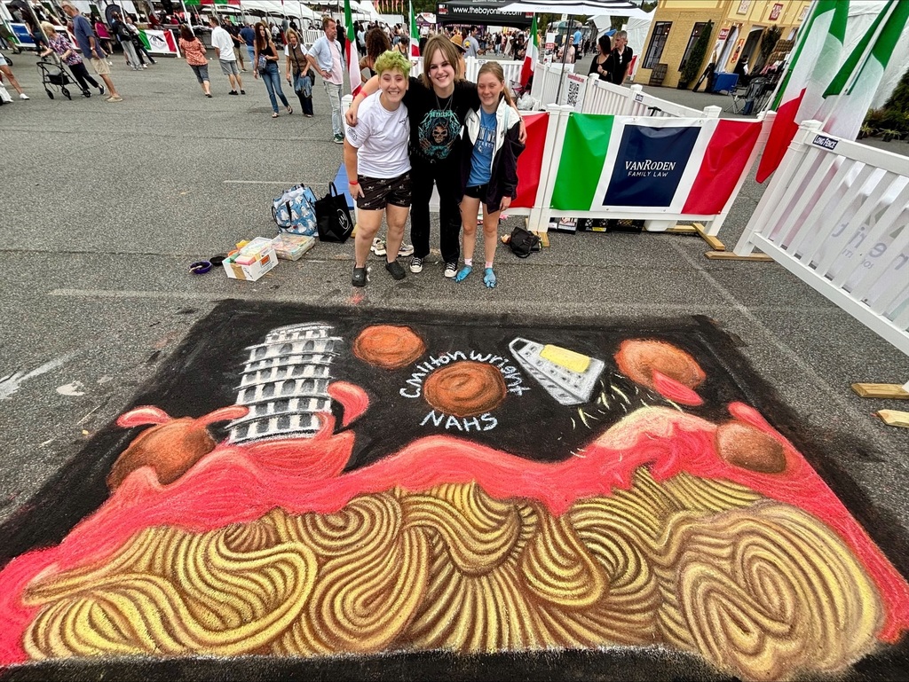 CMHS students pose with their chalk art