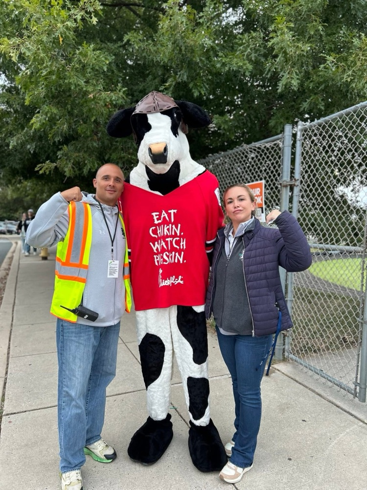 Cow mascot with two adults 