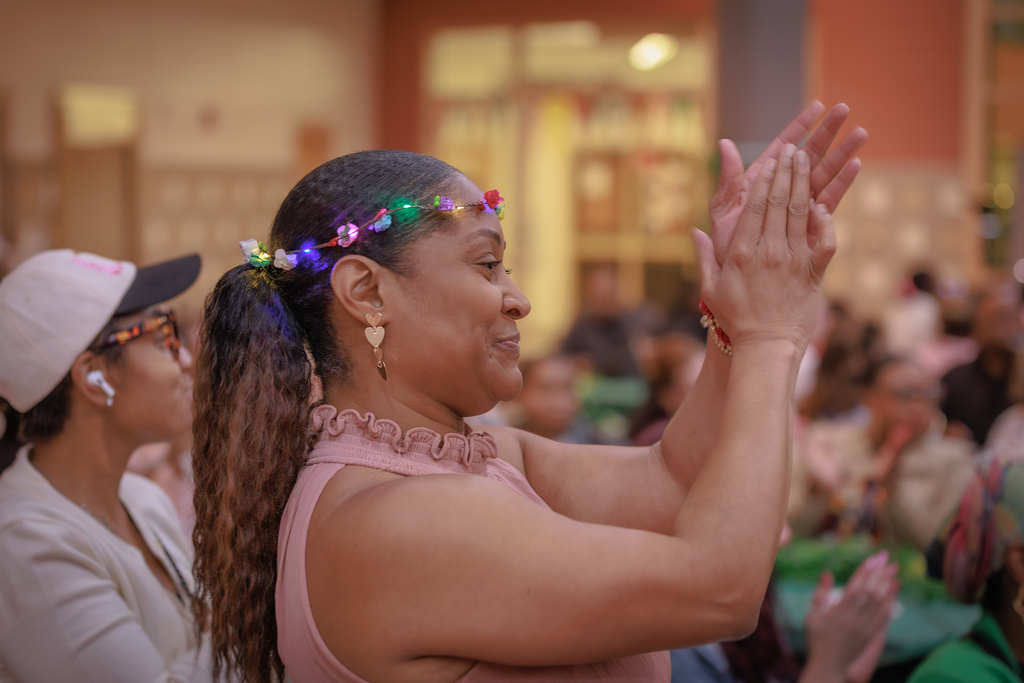Woman standing and clapping