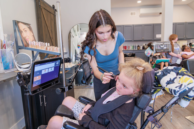 Stylist working on Harford Academy student's hair