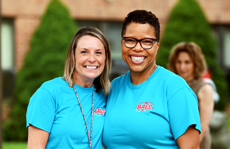 Dyann Mack smiles with principal Katie Scharpf