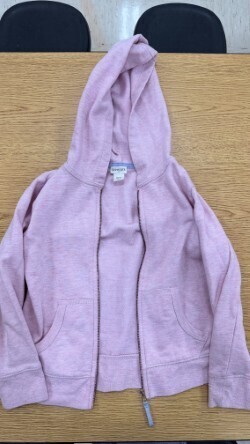 A collection of miscellaneous clothing items and cups in a variety of colors, styles, and sizes.