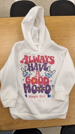 A collection of miscellaneous clothing items and cups in a variety of colors, styles, and sizes.