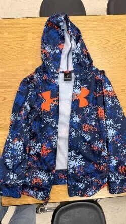 A collection of miscellaneous clothing items and cups in a variety of colors, styles, and sizes.