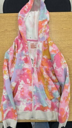 A collection of miscellaneous clothing items and cups in a variety of colors, styles, and sizes.