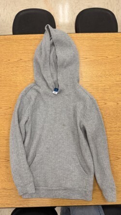 A collection of miscellaneous clothing items and cups in a variety of colors, styles, and sizes.