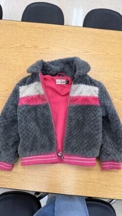 A collection of miscellaneous clothing items and cups in a variety of colors, styles, and sizes.
