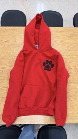 A collection of miscellaneous clothing items and cups in a variety of colors, styles, and sizes.