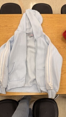 A collection of miscellaneous clothing items and cups in a variety of colors, styles, and sizes.