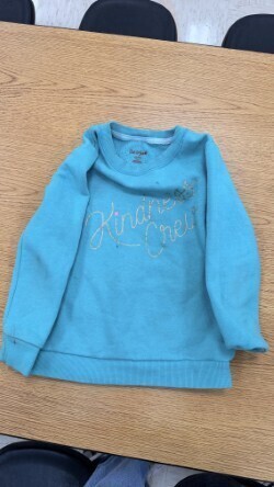 A collection of miscellaneous clothing items and cups in a variety of colors, styles, and sizes.