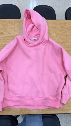 A collection of miscellaneous clothing items and cups in a variety of colors, styles, and sizes.