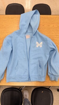 A collection of miscellaneous clothing items and cups in a variety of colors, styles, and sizes.