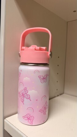 A collection of miscellaneous clothing items and cups in a variety of colors, styles, and sizes.