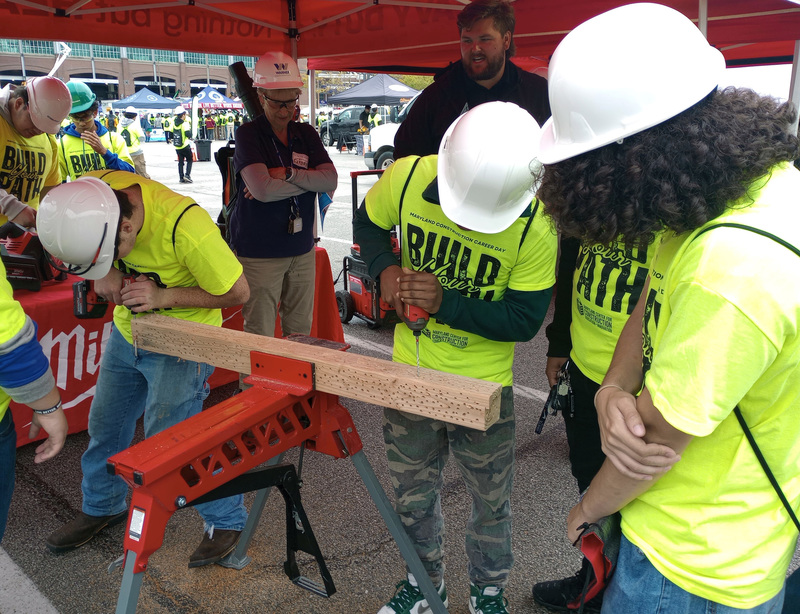 Students working with construction equipment