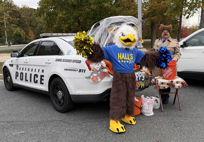 Aberdeen Mascot poses with Police Officer and Aberdeen Police car