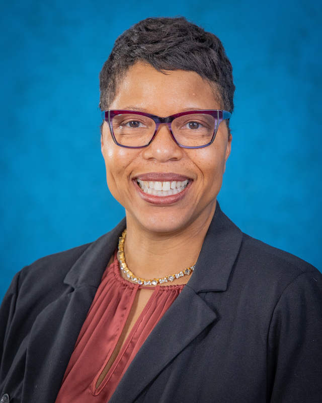 Dr. Dyann Mack poses for the camera with a smile.