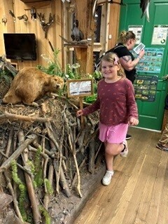 student with taxidermy beaver